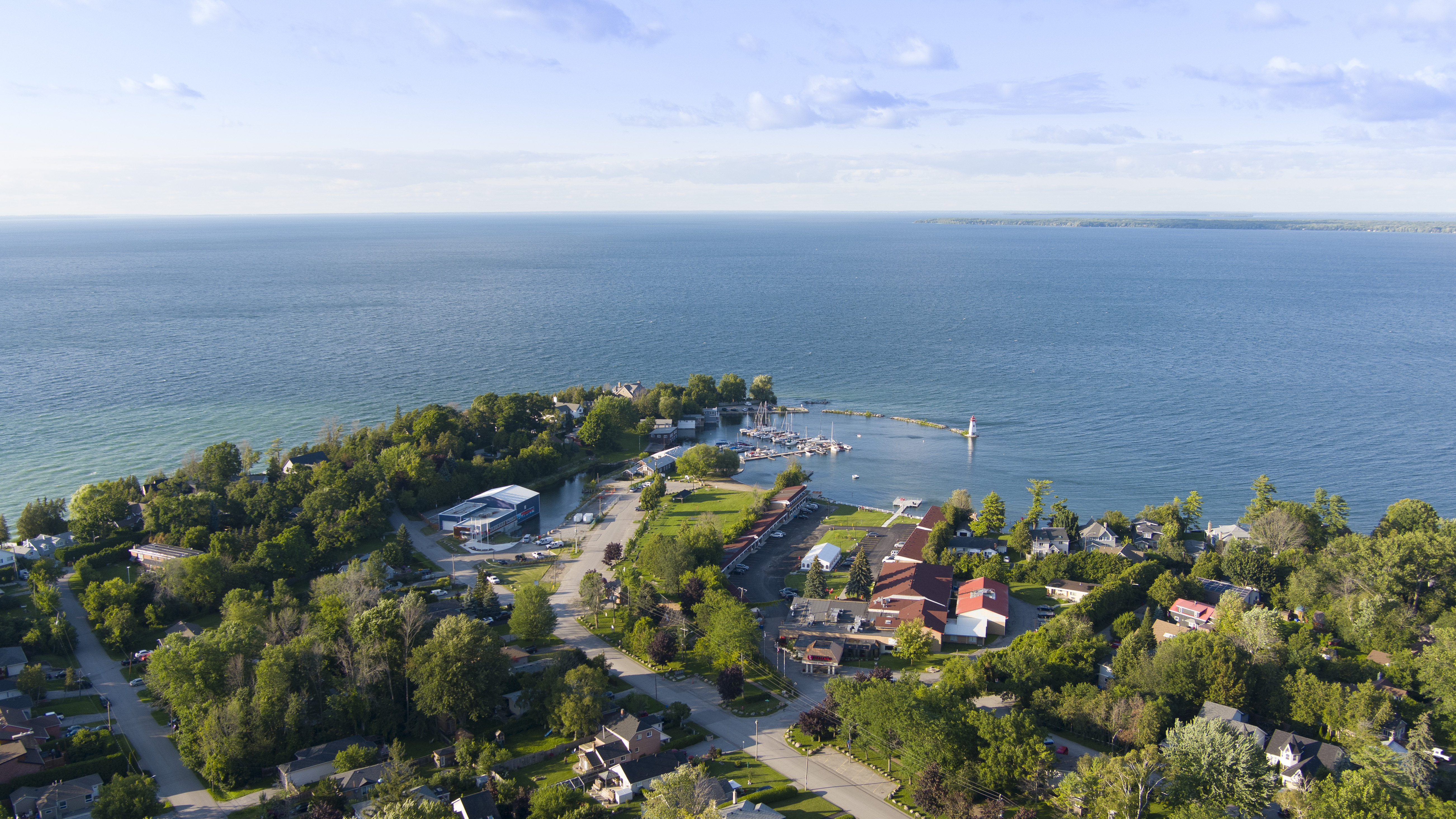 View of Lake Simcoe with a peninsula with buildings and trees on it 