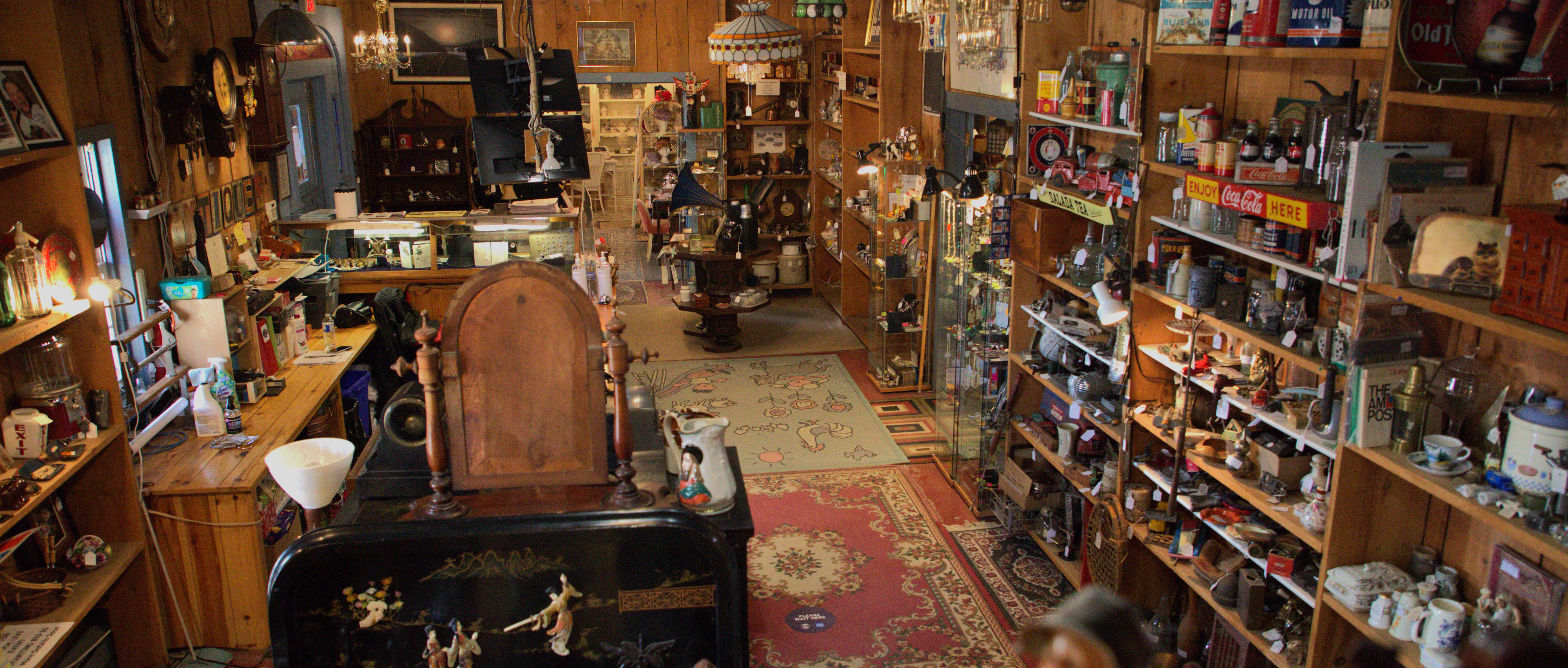 interior of an antique shop filled with shelves full of items
